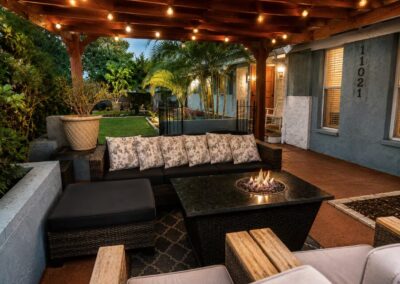 Outdoor lounge with fire table and pergola at The Salted Dream House.