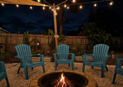 Fire pit seating area under string lights at The Salted Dream House.